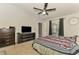 Comfortable bedroom with striped bedding, dresser, TV, and access to outside at 1858 Capitol St, North Port, FL 34288