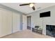 Bedroom with double doors, a TV, and built-in shelving at 1858 Capitol St, North Port, FL 34288
