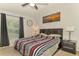Spacious bedroom with striped bedding, ceiling fan, and large window at 1858 Capitol St, North Port, FL 34288