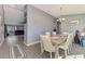 Open dining room with wood table and view to living room at 1858 Capitol St, North Port, FL 34288