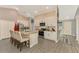 Eat-in kitchen with white cabinets, granite island, and stainless appliances at 1858 Capitol St, North Port, FL 34288