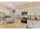Modern kitchen with white cabinets, granite counters, and stainless appliances at 1858 Capitol St, North Port, FL 34288