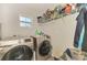 Laundry room with washer, dryer, and shelving at 1858 Capitol St, North Port, FL 34288