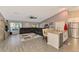 Spacious living room with a large sectional sofa, and kitchen island at 1858 Capitol St, North Port, FL 34288