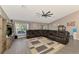 Living room with a sectional sofa, large TV, and kitchen views at 1858 Capitol St, North Port, FL 34288