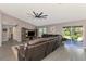 Open living room with a sectional sofa and access to the backyard at 1858 Capitol St, North Port, FL 34288