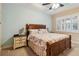 Comfortable bedroom with a ceiling fan and plenty of natural light at 2309 Vitiano Ct, Venice, FL 34292