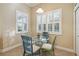 Bright breakfast nook with glass table and comfortable seating at 2309 Vitiano Ct, Venice, FL 34292