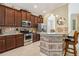 Island kitchen with granite countertops and stainless steel appliances at 2309 Vitiano Ct, Venice, FL 34292