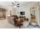 Comfortable living room featuring brown leather sofas and a view of a bedroom at 2309 Vitiano Ct, Venice, FL 34292