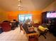 Living Room with orange walls, sliding glass doors, and seating at 2391 Briarwood St, Punta Gorda, FL 33980