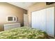 Bedroom with white wicker dresser and leafy patterned bedspread at 24488 Riverfront Dr, Punta Gorda, FL 33980