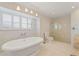 Relaxing bathroom with soaking tub, glass shower, and updated fixtures at 25380 Vantage Ln, Punta Gorda, FL 33983