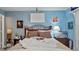 Bright bedroom with a double bed, neutral tones and wood furniture at 26485 Rampart Blvd # E7, Punta Gorda, FL 33983