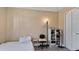 Modest bedroom featuring neutral walls, tile floors, and functional furnishings and closet for simple living at 26485 Rampart Blvd # E7, Punta Gorda, FL 33983