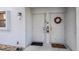Apartment entrance featuring a festive wreath, secure doors, and visible unit numbers at 26485 Rampart Blvd # E7, Punta Gorda, FL 33983