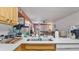 Open concept kitchen with view of the living room and stainless steel sink at 26485 Rampart Blvd # E7, Punta Gorda, FL 33983