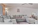 Comfortable living room with a large sectional sofa, stylish decor, and warm lighting at 26485 Rampart Blvd # E7, Punta Gorda, FL 33983