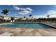 Enjoy this sparkling community pool surrounded by lounge chairs and palm trees for a resort-like experience at 26485 Rampart Blvd # E7, Punta Gorda, FL 33983