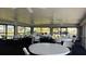 Bright community recreation room featuring abundant seating around tables perfect for social gatherings and activities at 26485 Rampart Blvd # E7, Punta Gorda, FL 33983