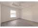 Spacious bedroom with large window, ceiling fan, and gray vinyl flooring at 27152 Monte Cristo Blvd, Punta Gorda, FL 33955