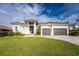 Two-story home with modern design, brown garage doors, and landscaped lawn at 2730 Saint Thomas Dr, Punta Gorda, FL 33950