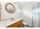 Bathroom featuring a wood vanity with marble countertop, a shower with glass door, and an ornate mirror at 3220 Peace River Dr, Punta Gorda, FL 33983