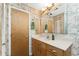 Bathroom with wood vanity and bamboo wallpaper at 3220 Peace River Dr, Punta Gorda, FL 33983