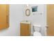 Simple bathroom with wood vanity and a toilet at 3220 Peace River Dr, Punta Gorda, FL 33983