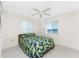 Bright bedroom with water views and a ceiling fan at 3220 Peace River Dr, Punta Gorda, FL 33983
