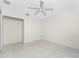Spacious bedroom with tile flooring and ceiling fan at 3220 Peace River Dr, Punta Gorda, FL 33983