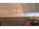Private boat dock with rainbow and sailboat at 3220 Peace River Dr, Punta Gorda, FL 33983