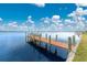 Dock with wood posts on a sunny day at 3220 Peace River Dr, Punta Gorda, FL 33983