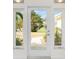 Inviting front entrance with a glass door framed by sidelight windows, offering a glimpse of the landscaped front yard at 3220 Peace River Dr, Punta Gorda, FL 33983