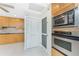 Bright kitchen with tile flooring, light wood cabinets, and stainless steel appliances at 3220 Peace River Dr, Punta Gorda, FL 33983