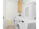 Laundry room with washer, dryer, and shelving at 3220 Peace River Dr, Punta Gorda, FL 33983