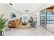 Living room with water views, features a comfy sofa and chairs at 3220 Peace River Dr, Punta Gorda, FL 33983