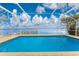 Inviting pool with beautiful water view from a screened enclosure, perfect for relaxation and enjoying the scenery at 3220 Peace River Dr, Punta Gorda, FL 33983