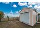 Large shed with a roll-up door, fenced in yard with a partial water view, and located next to boat ramp at 3220 Peace River Dr, Punta Gorda, FL 33983