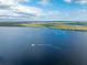 Aerial view of a scenic river with a boat leaving a wake at 3220 Peace River Dr, Punta Gorda, FL 33983