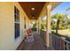 Relaxing front porch with rocking chairs and view of nature at 34775 Trails End Dr, Punta Gorda, FL 33982