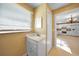 Small bathroom with vanity and view into kitchen at 511 Corto Andra St, Punta Gorda, FL 33950