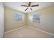 Spacious bedroom with two windows and ceiling fan at 511 Corto Andra St, Punta Gorda, FL 33950