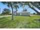 Newly renovated single-story home with a spacious lawn and palm trees at 511 Corto Andra St, Punta Gorda, FL 33950
