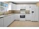 Modern kitchen with white cabinets and granite countertops at 511 Corto Andra St, Punta Gorda, FL 33950