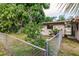 Fenced backyard with lush landscaping and trees at 515 W Olympia Ave, Punta Gorda, FL 33950