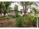 Mature trees and a partially fenced backyard with established landscaping at 515 W Olympia Ave, Punta Gorda, FL 33950