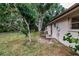 Spacious backyard with mature trees and a partially fenced area at 515 W Olympia Ave, Punta Gorda, FL 33950