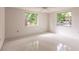 Empty bedroom with two windows and ceiling fan at 515 W Olympia Ave, Punta Gorda, FL 33950