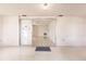 Sunlit entryway showcasing a sliding glass door and terrazzo flooring at 515 W Olympia Ave, Punta Gorda, FL 33950